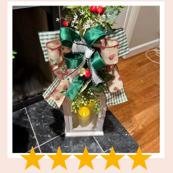 Decorative lantern with a large bow on a marble surface